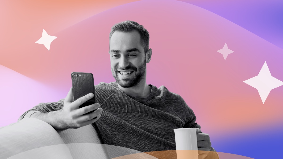 Smiling man holding a coffee mug and looking at his phone, set against a pink and purple gradient with sparkle accents