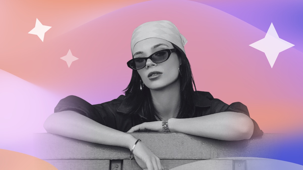 Woman in sunglasses and a bandana leaning on a wall, set against a pink and purple gradient with sparkle accents