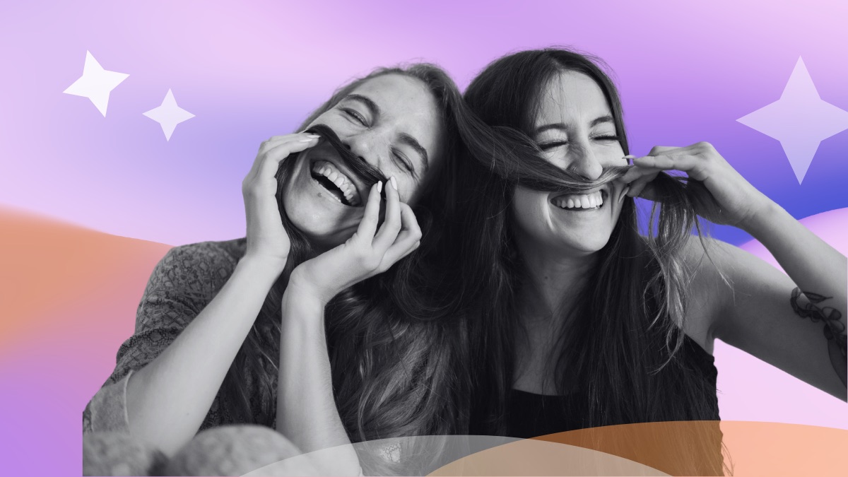 Two laughing friends holding their hair up like moustaches, set against a pink and purple gradient with sparkle accents