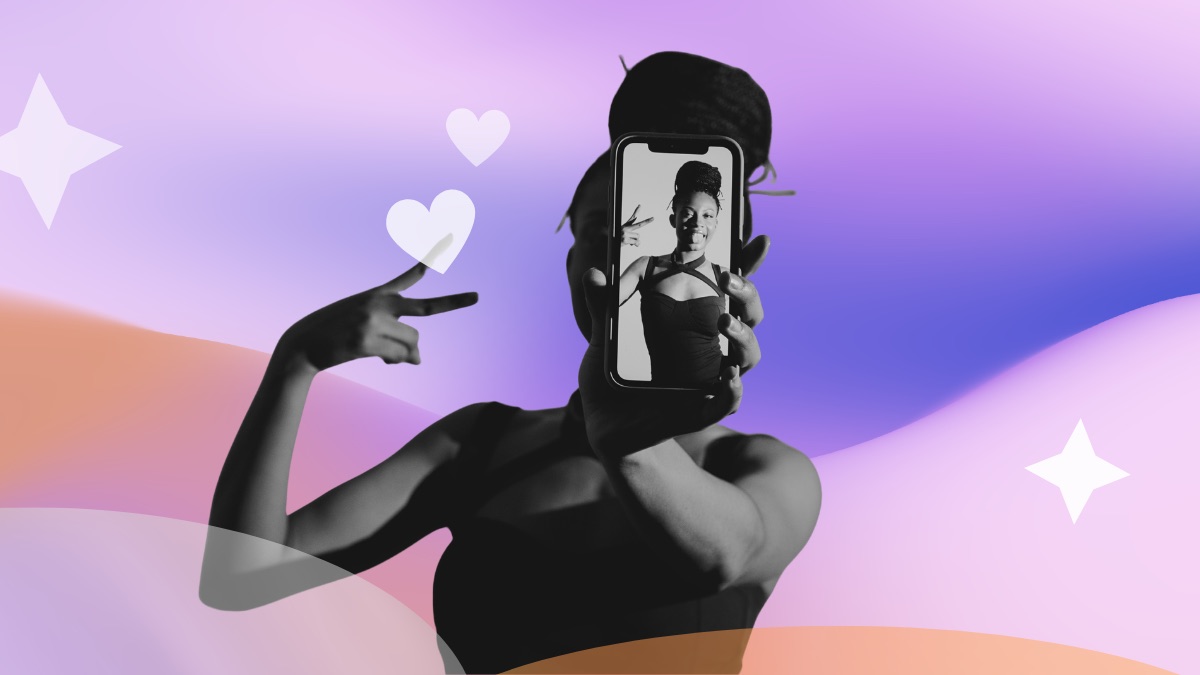 Woman making a peace sign and holding up a phone showing her own photo, set against a pink and purple gradient with hearts and sparkles